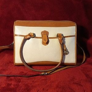 Dooney and  Burke cream colored all weather leather handbag with tan trim.